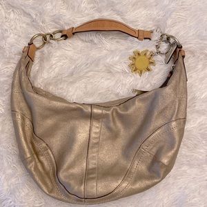 Coach gold leather hobo bag w sun Coach leather charm.Bag is 16inW 8.5inH.